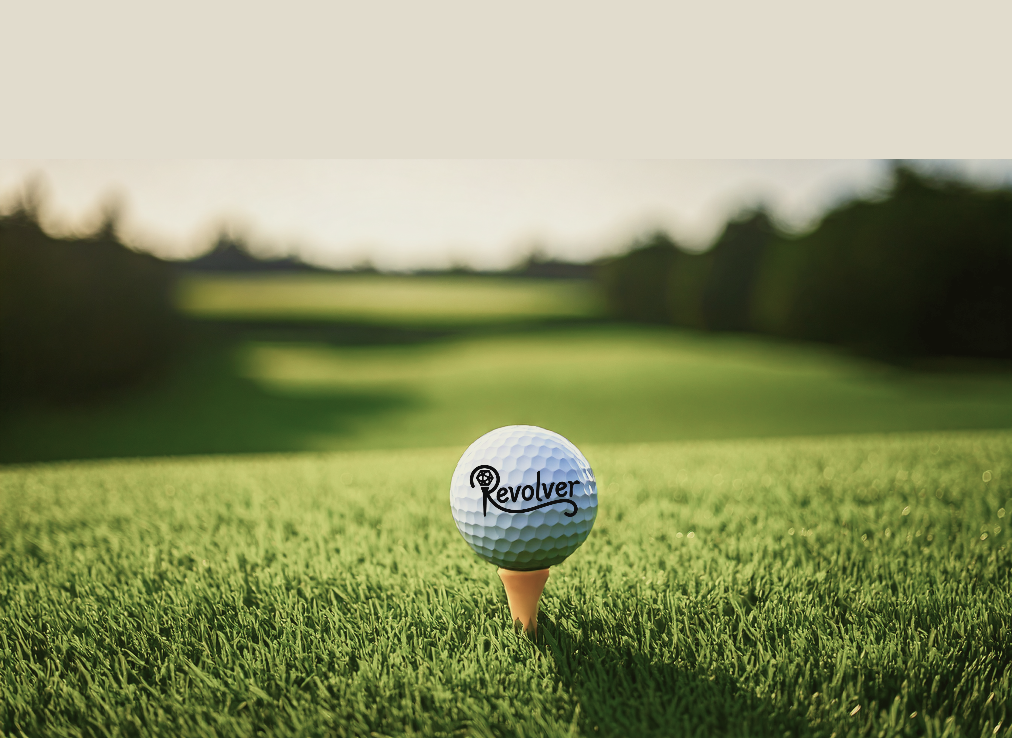 Golf ball teed up with the Revolver logo